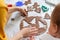 Mother and baby together cut out cookies from the dough. Top view from the shoulder. Close up of table. Christmas concept and