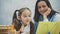 Mother becoming frustrated with daughter whilst doing homework sitting at the table at home in learning difficulties