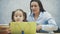 Mother becoming frustrated with daughter whilst doing homework sitting at the table at home in learning difficulties