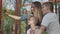 Mother with blond long hair making a photo with her two young sons in the playground