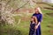 Mother blond woman and daughter outdoors on spring flowers background