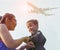 Mother and boy dreaming to be a plane pilot