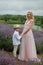 Mother with boy holding hands have a rest in lavender field