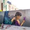 Mother braiding her daughter& x27;s hair in traditional dress street art in jumeirah in Dubai