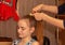 Mother braids hair young daughter