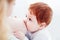 Mother breastfeeding her adorable ginger baby. Baby looks at mom, bonding concept