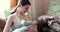 Mother breastfeeding her newborn baby on sofa. Milk from mother\'s breast is a natural medicine to baby. family, food