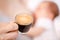 Mother breastfeeding newborn baby drinking coffee