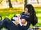 Mother breastfeeding outdoors in city parkland.