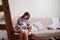 Mother breastfeeds a newborn at home on the couch. the benefits of breastfeeding