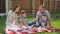 Mother with brown hair sits with handsome father and boys