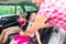 Mother buckling up on child - car safety seat