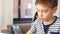 Mother calling on phone and son learning at home