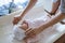 Mother carefully dresses her newborn baby