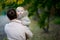 Mother carries away a child who is looking at the camera