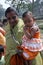 Mother carries the little girl to Mass, Sundarbans, West Bengal, India