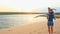 Mother Carries Small Girl on Shoulders on Dunes