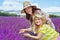 Mother and child against lavender field exploring lavender