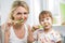 Mother and child brushing teeth in bathroom