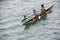 Mother and child in canoe on Pacific Ocean