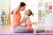 Mother and child daughter engaged in fitness, yoga, exercise at home