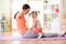 Mother and child daughter are engaged in fitness, yoga, exercise at home. Kid and woman swing press on stomach.