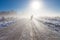 Mother and child on foggy snow farm road