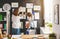 Mother and child girl hang their drawings on wall