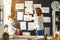 Mother and child girl hang their drawings on wall