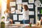 Mother and child girl hang their drawings on wall