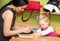 Mother and child girl playing in kindergarten in Montessori preschool
