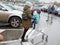 Mother and child go to the mall. Walking with an empty trolley in a parking lot