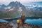 Mother and child hiking together on a family travel adventure in Senja island, Norway, scenic mountain trails with fjord view