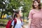 Mother and child holding hands going to school