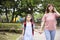 Mother and child holding hands going to school