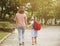 Mother and child holding hands going to school