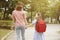 Mother and child holding hands going to school