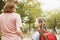 Mother and child holding hands going to school