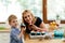 Mother and child joyfully eating muffins