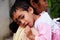 Mother with child during an outdoor Mass in Mitrapur, West Bengal, India