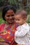 Mother with child during an outdoor Mass in Mitrapur, West Bengal, India