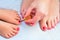 Mother and child paint their feet with nail polish