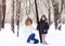 Mother and child playing in deep snow on sunset