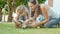 Mother and child playing with puppy on a warm summer day outdoor