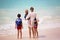 Mother and child playing at tropical beach. Family sea summer vacation. Mom and kid, toddler boy, play in the water. Ocean and
