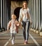 Mother and child on Pont de Bir-Hakeim bridge going forward