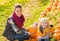 Mother and child among pumpkin