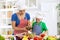 Mother and child putting olive oil to vegetables lettuce