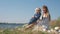 Mother-child relationship, cheerful female playing with little boy during family picnic in nature close up in meadow