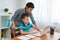 Mother and child school student at home on a laptop learning homework. e-home schooling during the period of the